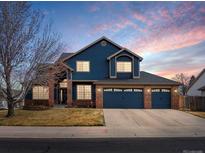 Charming two-story home featuring a three-car garage and a well-maintained front yard at 8346 Vivian St, Arvada, CO 80005
