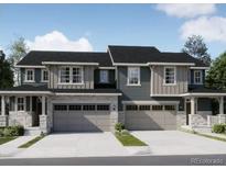 Attractive townhome with stone accents, a gray color palette, and a two car garage at 6770 Juniper Dr, Thornton, CO 80602
