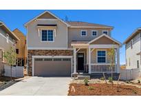 Charming two-story home with a stone facade, covered porch, and attached garage at 459 S Salida St, Aurora, CO 80017