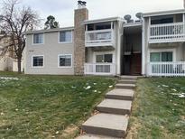 Two-story condo building with grassy yard and stairs leading to entrance at 14141 E Jewell Ave # 102, Aurora, CO 80012