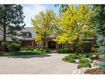 Charming brick home with a circular driveway and mature landscaping at 5851 S Colorado Blvd, Greenwood Village, CO 80121
