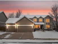 Two-story house with a three-car garage and snow-covered yard at 6460 W 98Th Ct, Westminster, CO 80021