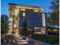 Striking modern home boasts clean lines, a flat roof, and professional landscaping with integrated walkway lighting at 35 S Forest St, Denver, CO 80246