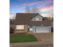 Charming two-story home with gray siding, brick accents, and a well-maintained front yard at 3311 E Euclid Ave, Centennial, CO 80121