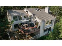 Back exterior view from above showcasing deck and trees at 947 Dogwood Dr, Golden, CO 80401