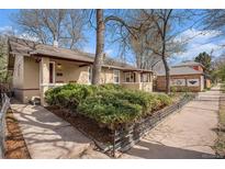 Charming bungalow-style home with manicured landscaping and inviting front porch at 3726 Decatur St, Denver, CO 80211