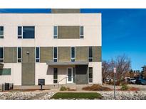 Modern townhouse with neutral-toned exterior, many windows, and minimalist landscaping on a sunny day at 3207 W 17Th Ave, Denver, CO 80204