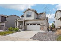 Two-story home with stone accents, gray siding, a two-car garage and a concrete driveway at 12797 Clearview St, Firestone, CO 80504
