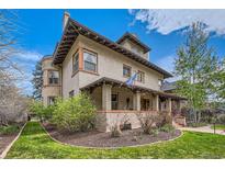 Charming brick two-story home with a covered front porch and manicured lawn at 680 N Emerson St, Denver, CO 80218