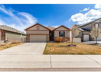 Charming ranch-style home with a two-car garage and nicely xeriscaped front yard at 10266 Stagecoach Ave, Firestone, CO 80504