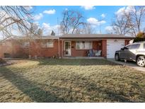 Charming single-story brick home with a well-maintained lawn and inviting front porch at 3023 S Fenton St, Denver, CO 80227