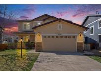 Front exterior of a two-story home featuring an attached garage and well-manicured lawn at 6370 Twilight Ave, Firestone, CO 80504