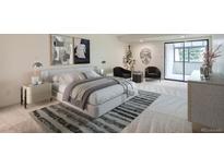 Bright main bedroom boasts a large bed, balcony access, and stylish decor at 7000 E Quincy Ave # 317, Denver, CO 80237