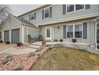 Close up of front porch with chairs, potted plants, and decorative rock landscaping at 16816 E Villanova Cir, Aurora, CO 80013