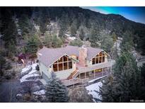 Charming mountain home with large windows, deck and stone chimney at 2218 Witter Gulch Rd, Evergreen, CO 80439