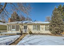 Ranch style home with a snow-covered yard and mature trees at 2253 Columbine Ave, Boulder, CO 80302