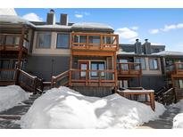 Exterior view of a modern condo with snowy landscape and wooden balconies at 147 Illinois Gulch Rd # 4, Breckenridge, CO 80424