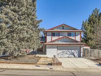 Two-story house with attached garage and mature landscaping at 1490 S Iris St, Lakewood, CO 80232