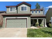 Two-story home featuring an attached garage, covered entryway, and well-maintained lawn at 5327 Suffolk Cir, Castle Rock, CO 80104