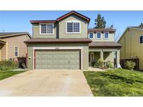 Two-story home showcasing a two-car garage and well-maintained lawn, offering an inviting curb appeal at 5327 Suffolk Cir, Castle Rock, CO 80104