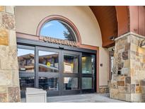Welcoming stone entrance to the Chateaux building with automatic doors, great location and amenities at 405 Village Rd # 405, Breckenridge, CO 80424