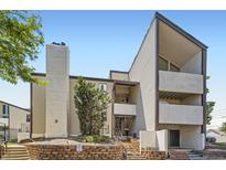 Contemporary apartment building featuring a concrete chimney and stairways to upper-level units at 3539 S Fairplay Way # 10, Aurora, CO 80014