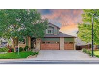 Inviting two-story home features a three-car garage, lush landscaping and a well-maintained lawn at 16873 Boreas Ct, Parker, CO 80134
