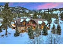 Spacious multi-story home with snow-covered roof, stone accents, and beautiful mountain views at 59 Gold Run Rd, Breckenridge, CO 80424