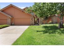 Charming home featuring an attached garage, well-maintained lawn, and mature landscaping at 16052 Deer Ridge Dr # B, Morrison, CO 80465