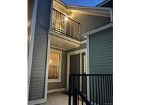 Charming exterior view showcasing gray siding, a balcony, and an inviting entrance at 6711 S Ivy Way # B5, Centennial, CO 80112