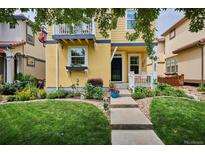 Charming yellow two-story home with a well-manicured lawn and beautiful landscaping at 9311 E 5Th Ave, Denver, CO 80230