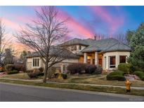 Charming home with well-manicured lawn, mature trees, and elegant brick and stone accents at 5350 S Marshall St, Littleton, CO 80123