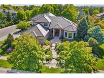 Stunning home featuring lush landscaping, tile roof, and an inviting entrance in a well-maintained community at 5350 S Marshall St, Littleton, CO 80123