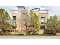 Contemporary building with a sleek design, offering balconies and modern architectural details and mature trees at 2314 S University Blvd, Denver, CO 80210