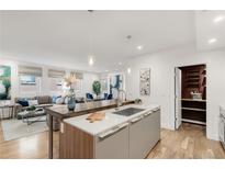 Bright kitchen with stainless steel appliances and an open floor plan to living room at 2314 S University Blvd, Denver, CO 80210