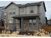 Charming two-story home featuring stone accents and a welcoming covered porch at 9010 W 100Th Way, Broomfield, CO 80021