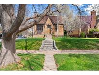 Charming brick home with well-maintained front yard and inviting entryway, creating a warm curb appeal at 2088 Kearney St, Denver, CO 80207