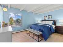 Comfortable bedroom with large window, ceiling beams and ample closet space at 4801 E 9Th Ave # 209S, Denver, CO 80220