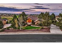 Beautiful home with lush landscaping, mature trees, a red front door, and a view of the golf course and neighborhood at 5149 Raintree Dr, Parker, CO 80134