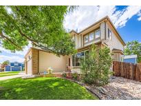 Charming two-story home featuring brick and siding accents, lush landscaping, and a welcoming front porch at 5133 E Essex Ave, Castle Rock, CO 80104