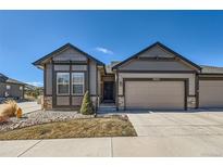 Charming single-Gathering home featuring a two-car garage, neutral paint scheme, and a manicured front yard at 11926 Barrentine Loop, Parker, CO 80138