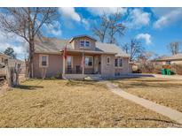 Charming single-Gathering home featuring a welcoming front porch and well-maintained lawn at 1177 Jamaica St, Aurora, CO 80010