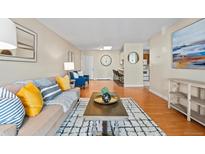 Open concept living area with comfortable sofa and adjacent kitchen, creating a welcoming living space at 7740 W 35Th Ave # 303, Wheat Ridge, CO 80033