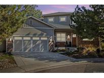 Charming two-story home featuring a gray exterior, attached garage, and well-manicured landscaping at 4193 W 99Th Ct, Westminster, CO 80031