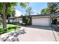 Charming single-story home with a well-manicured lawn and a two car garage at 4545 S Lipan Ct, Englewood, CO 80110