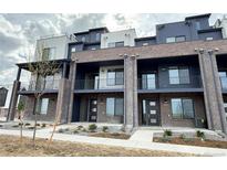 Modern townhome with brick facade, balconies, and contemporary design at 8321 Mount Kataka St, Littleton, CO 80125