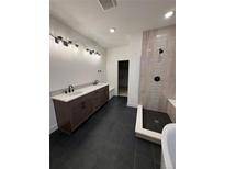 Modern bathroom featuring double vanity, walk-in shower with tile accents and black fixtures at 5626 W 142Nd Ave, Broomfield, CO 80020