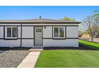 Charming front exterior with a well-maintained lawn, accented by fresh mulch at 3200 N Elizabeth St, Denver, CO 80205