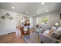 Bright, open-concept living room with modern decor, wood floors, and plenty of natural light at 3200 N Elizabeth St, Denver, CO 80205