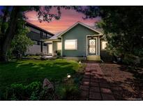 Charming home featuring a well-maintained lawn, garden beds, and a brick pathway to the front door at 1451 S Columbine St, Denver, CO 80210